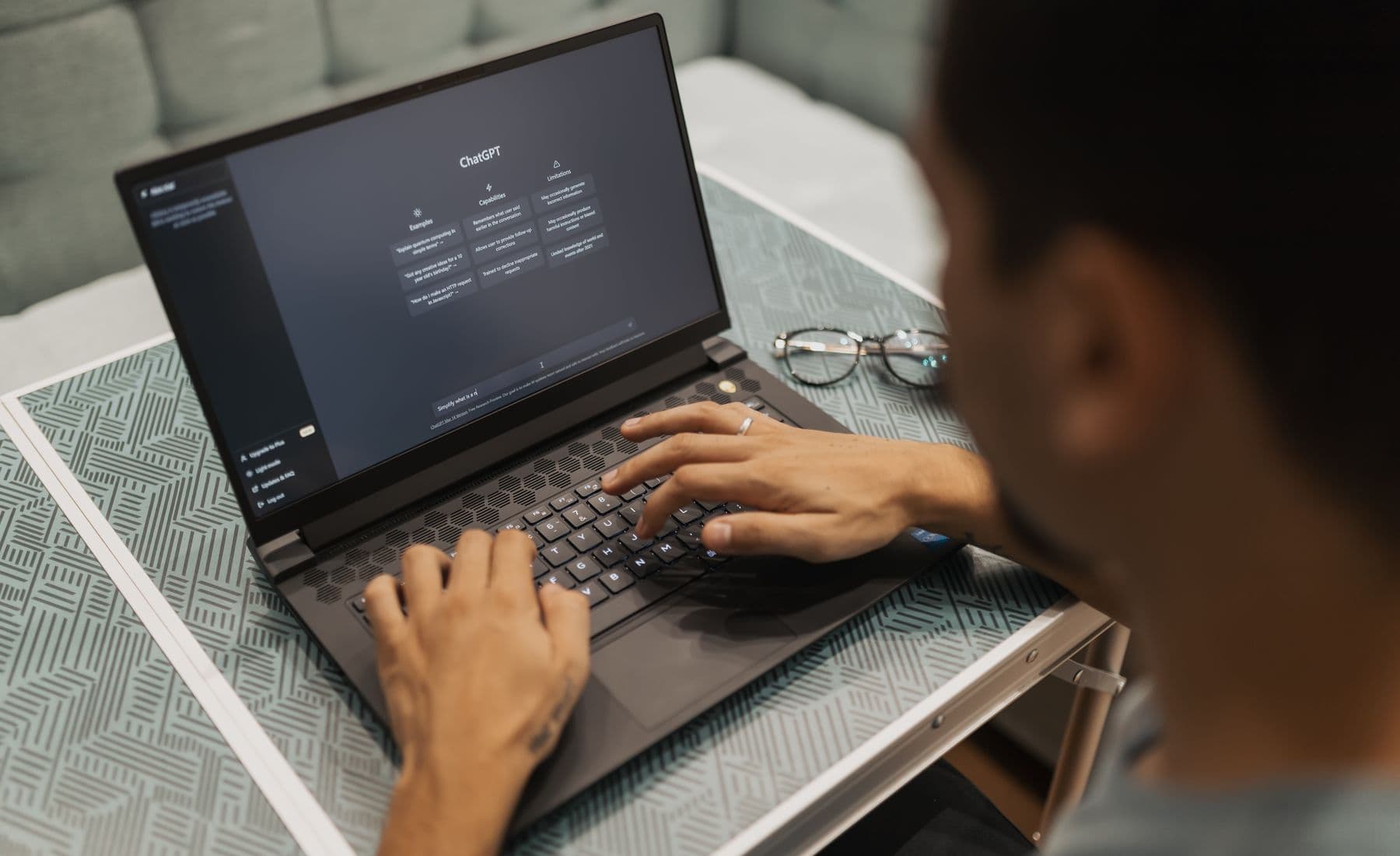 Founder using an AI assistant on a laptop while working from home.