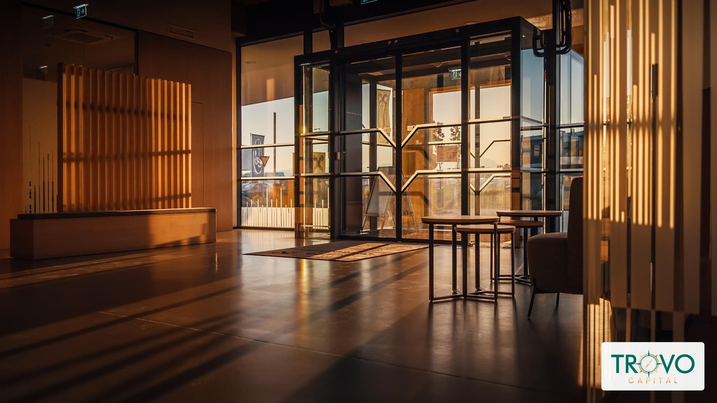 Street-level view through the glass entrance of a modest neighborhood bank lobby