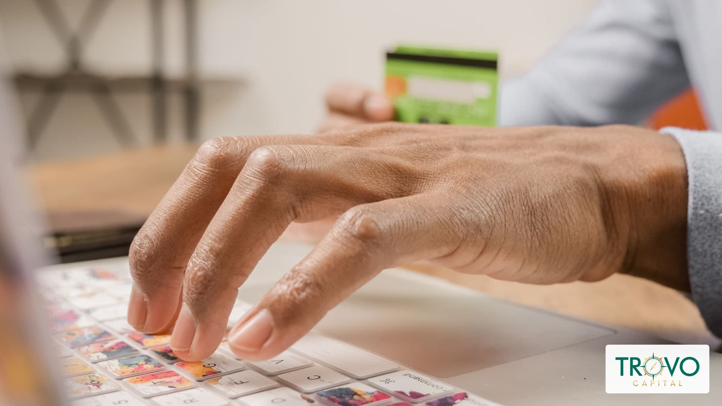 Close-up of a warehouse finance employee using a laptop and security key to access business banking.