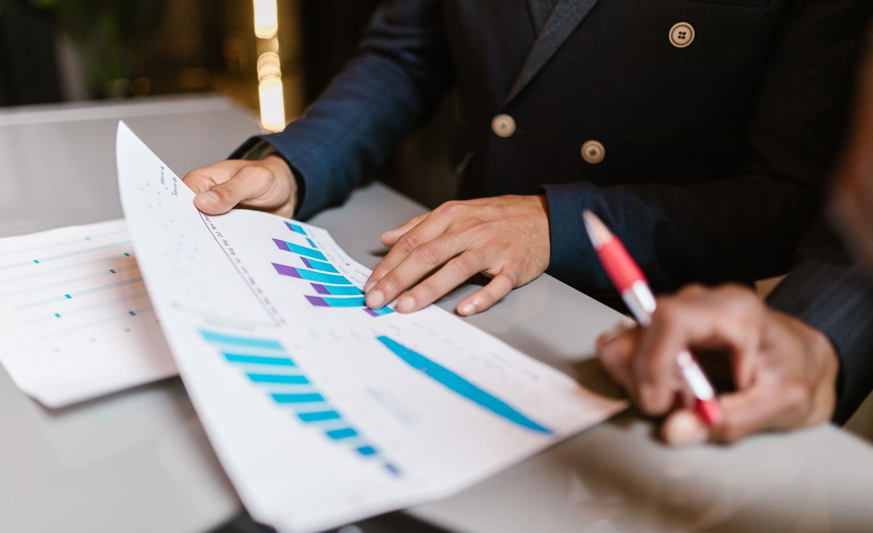 Advisors reviewing financial graphs during a business meeting.